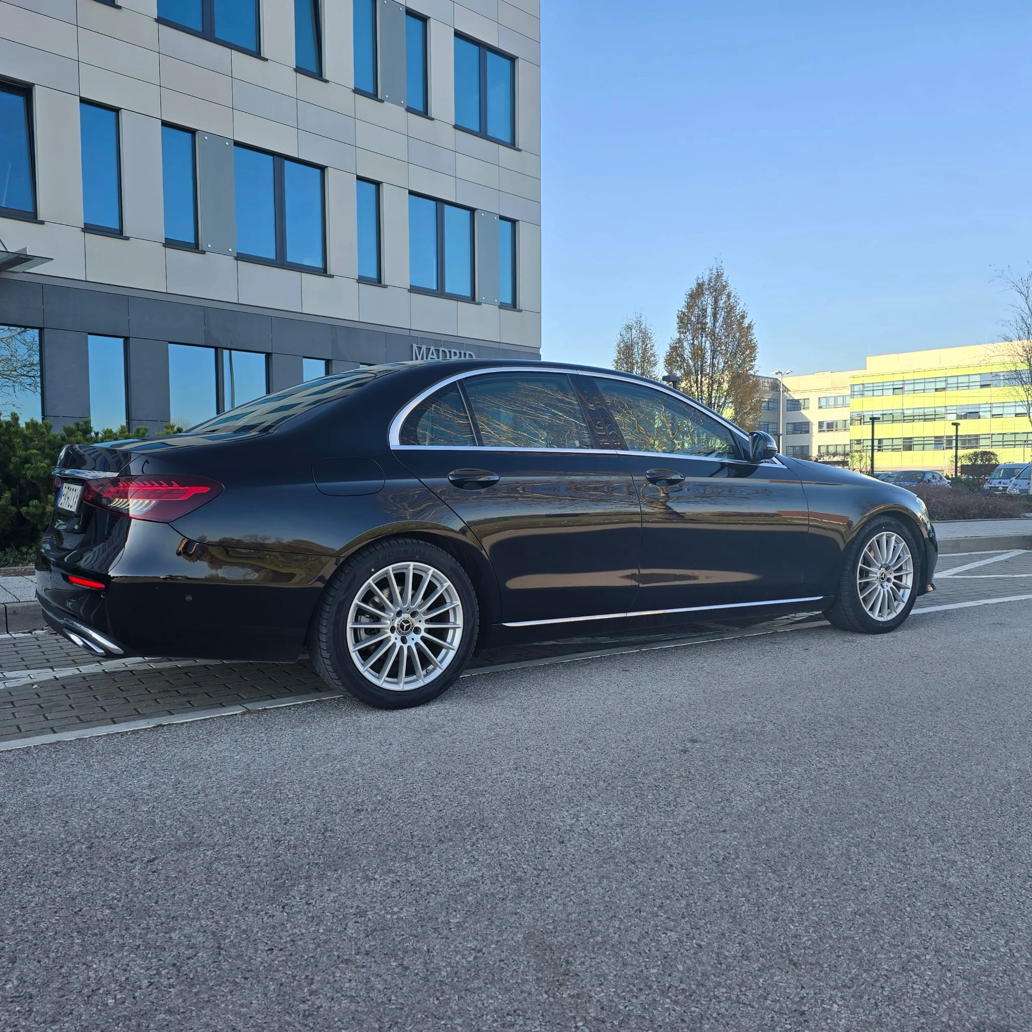 Czarny Mercedes klasy S na tle nowoczesnego biurowca
